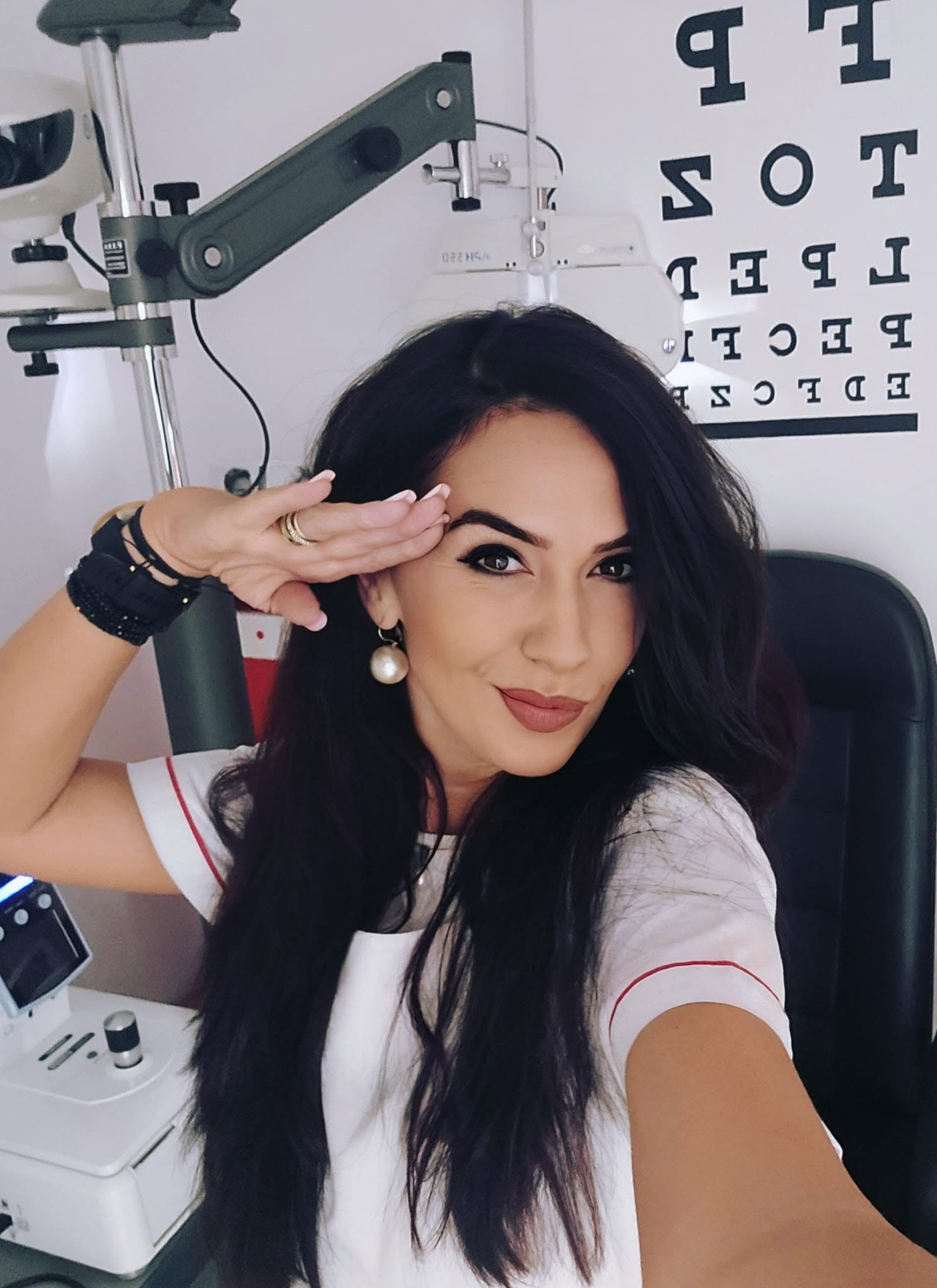 Verificarea vederii la OptiK Design Galați Optometristă OptiK Design în timpul unei verificări a vederii, folosind aparatura de optometrie.